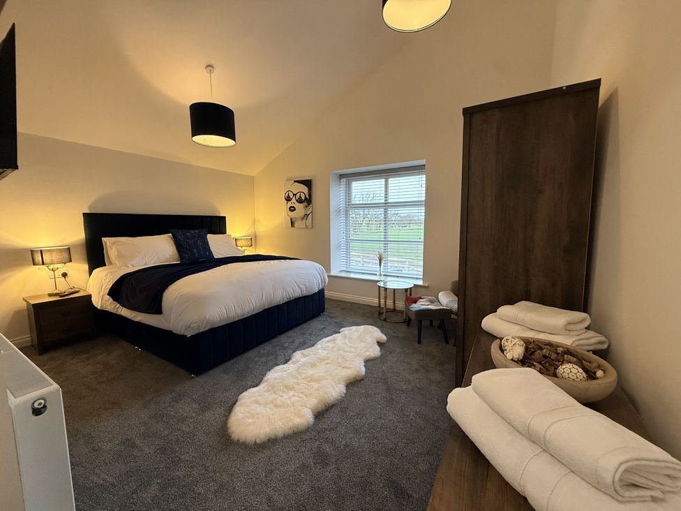 A bedroom with a bed and bedside table at The Barn in Wigglesworth near Settle