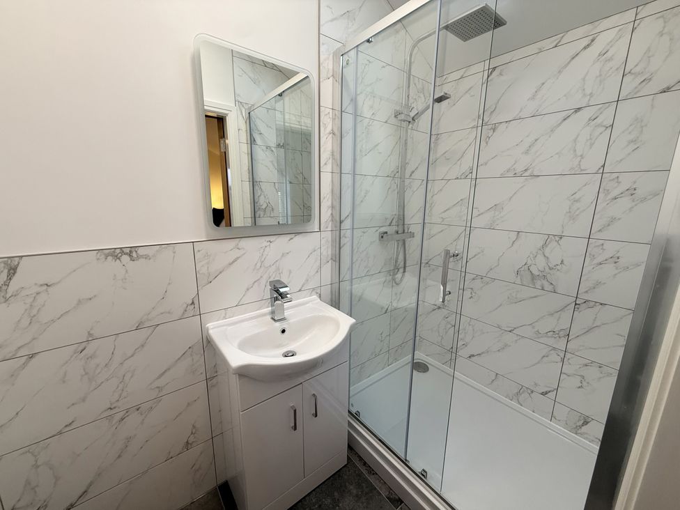 A bathroom with a sink and shower enclosure at The Barn in Wigglesworth near Settle