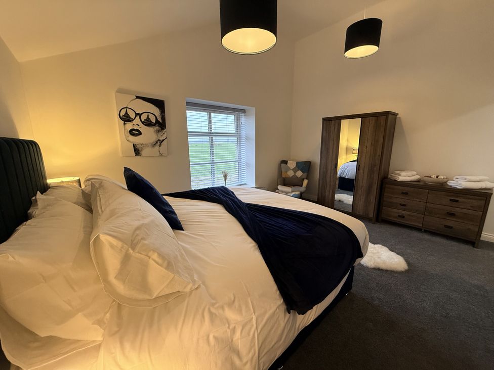 A bedroom with a bed and wardrobe at The Barn in Wigglesworth near Settle