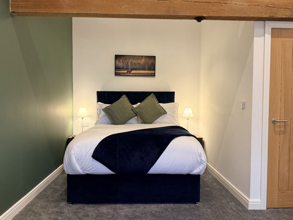 A bedroom with a bed and lamps at The Barn in Wigglesworth near Settle