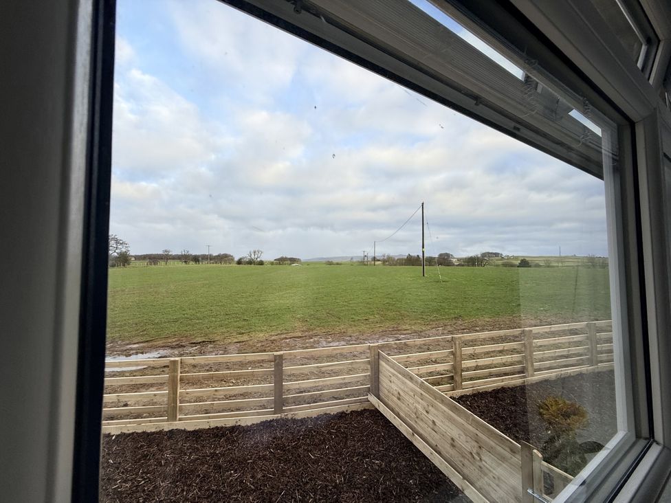 A view of a field with a fence and power pole at The Barn in Wigglesworth near Settle