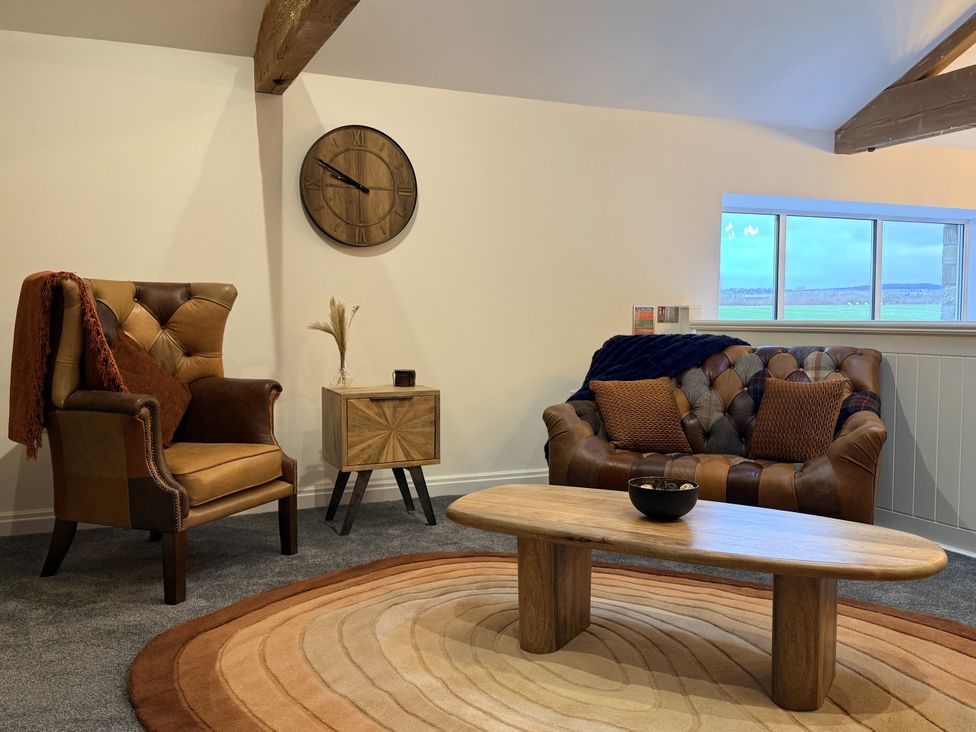 A living room with seating and a coffee table at The Barn in Wigglesworth near Settle