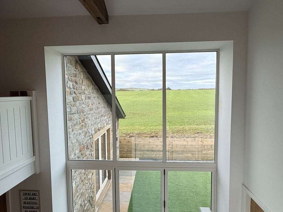 A window overlooking a grassy area at The Barn in Wigglesworth near Settle