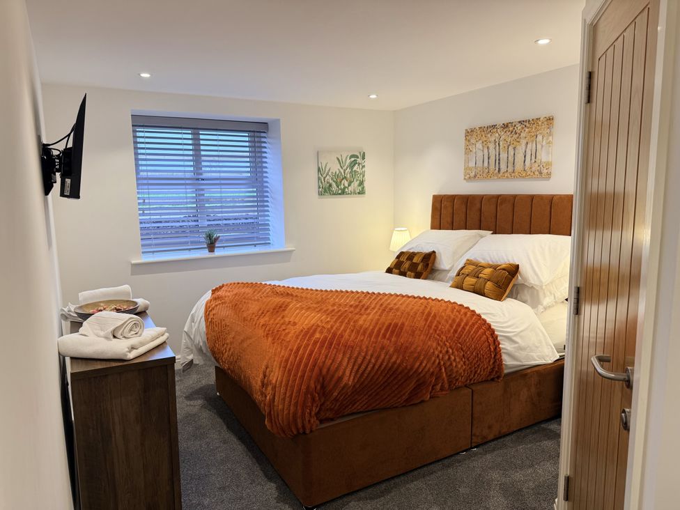 A bedroom with a bed and a television at The Barn in Wigglesworth near Settle