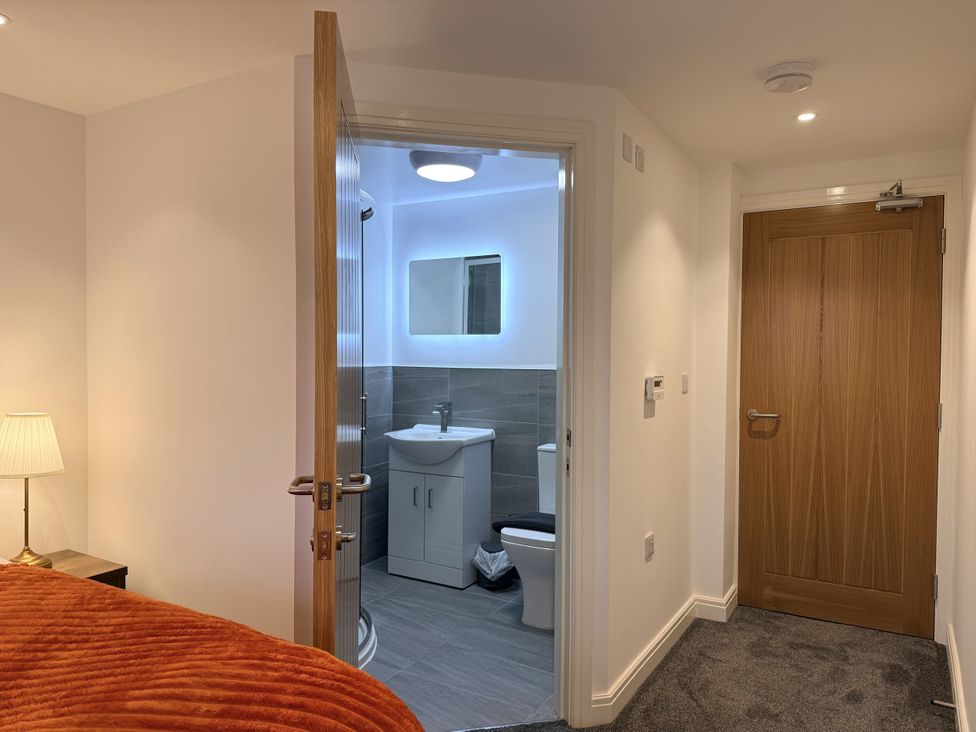 A bedroom with a view into an adjoining bathroom at The Barn in Wigglesworth near Settle