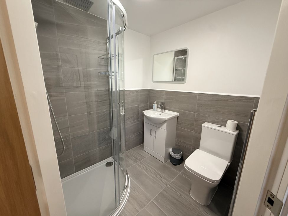 A bathroom with a shower, toilet, and sink at The Barn in Wigglesworth near Settle
