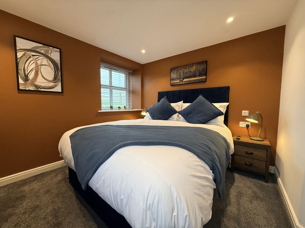 A bedroom with a bed and bedside table at The Barn in Wigglesworth near Settle
