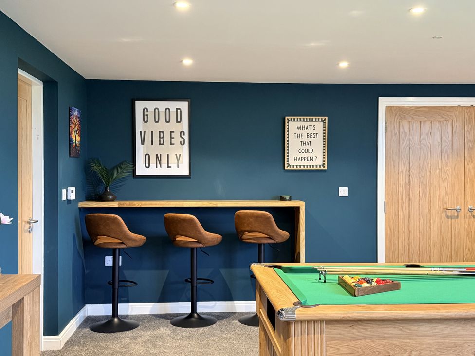 A snug with bar stools and a pool table at The Barn in Wigglesworth near Settle