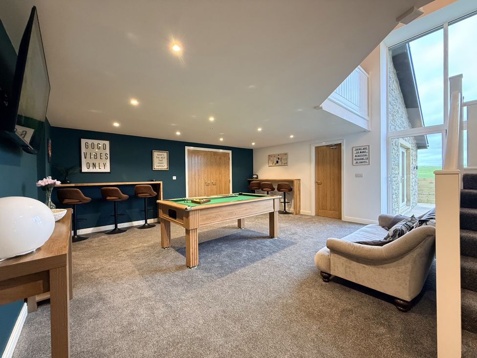 A snug with a pool table and seating area at The Barn in Wigglesworth near Settle