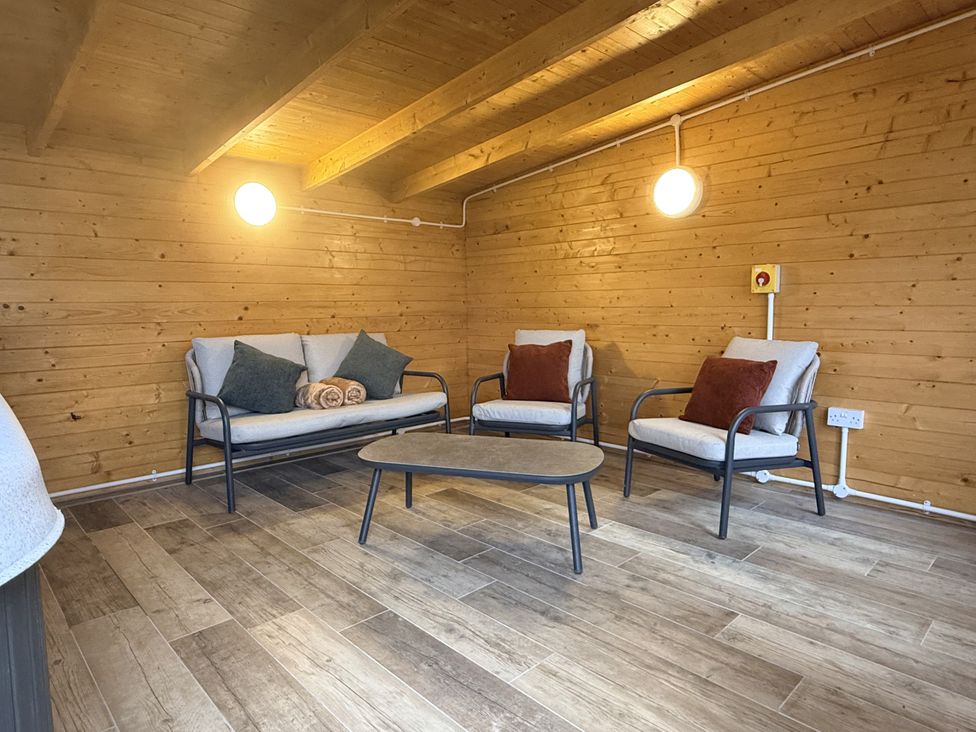 A snug with seating and a table at The Barn in Wigglesworth near Settle