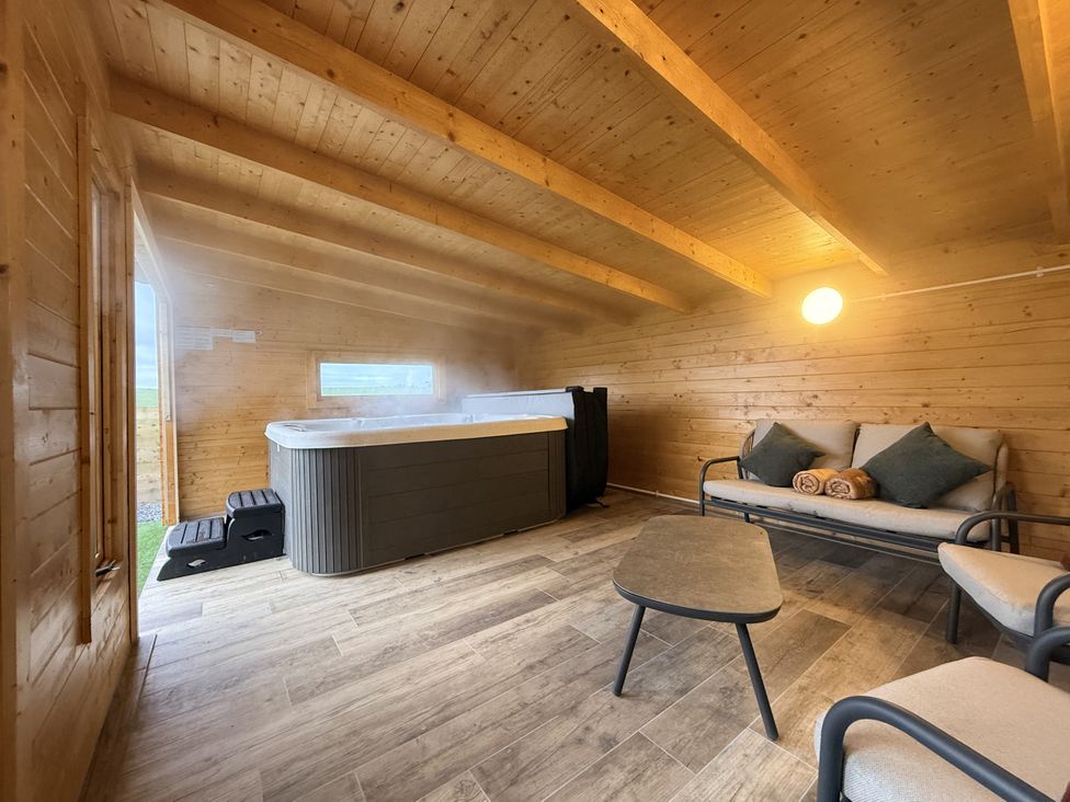 A hot tub in a wooden room at The Barn in Wigglesworth near Settle