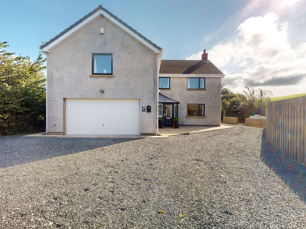 A house with a garage and driveway at Low Greenlands House Tewitfield