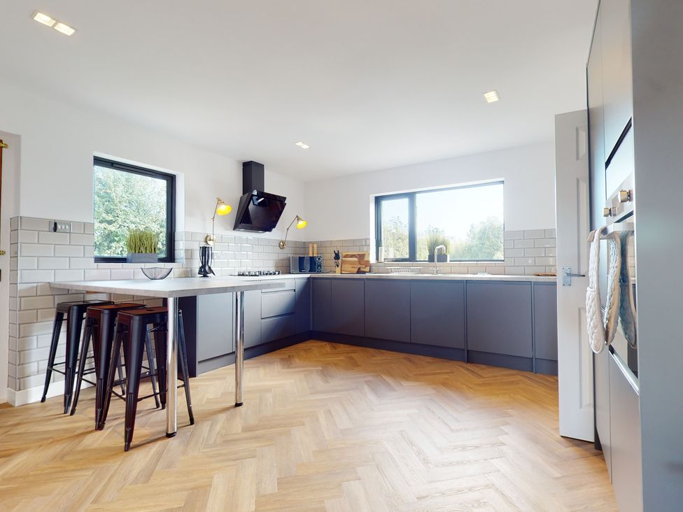 A kitchen with a stove and countertop at Low Greenlands House Tewitfield