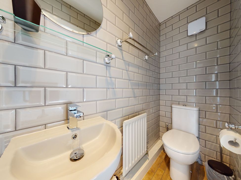 A bathroom with a sink and toilet at Low Greenlands House in Tewitfield
