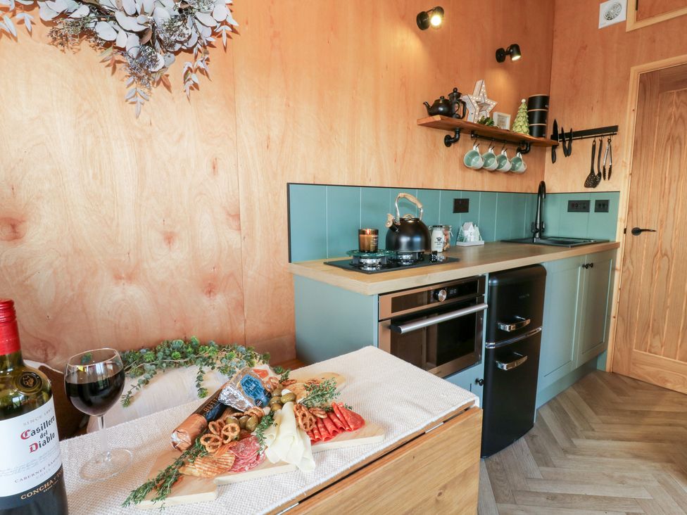 A kitchen with a variety of food items and appliances at Harriet in Llangurig