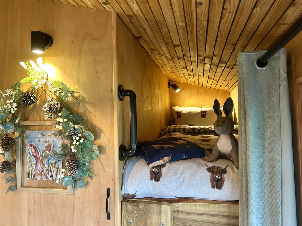 A bedroom with a bed and a stuffed animal at Harriet in Llangurig