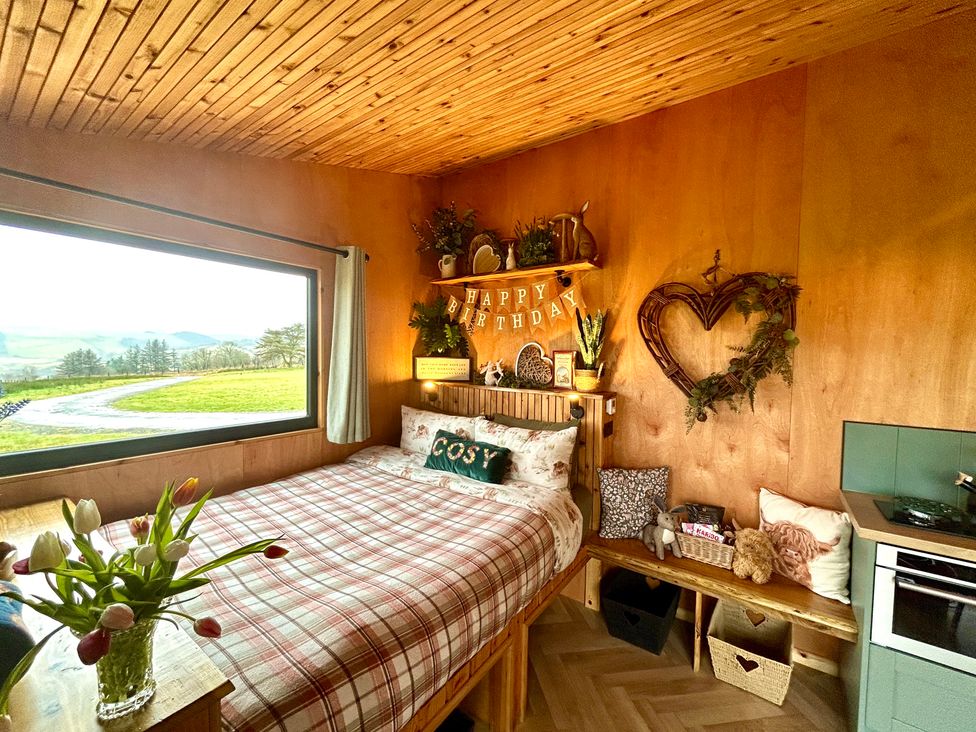 A bedroom with a bed and shelf at Harriet in Llangurig