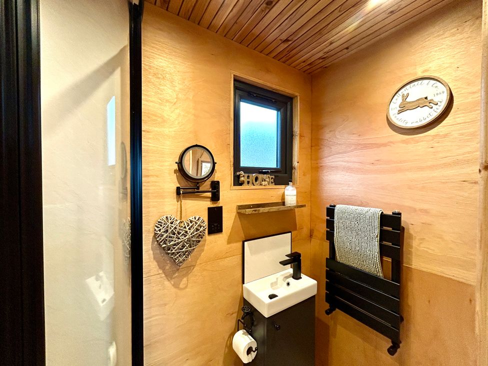 A bathroom with a sink and mirror at Harriet in Llangurig