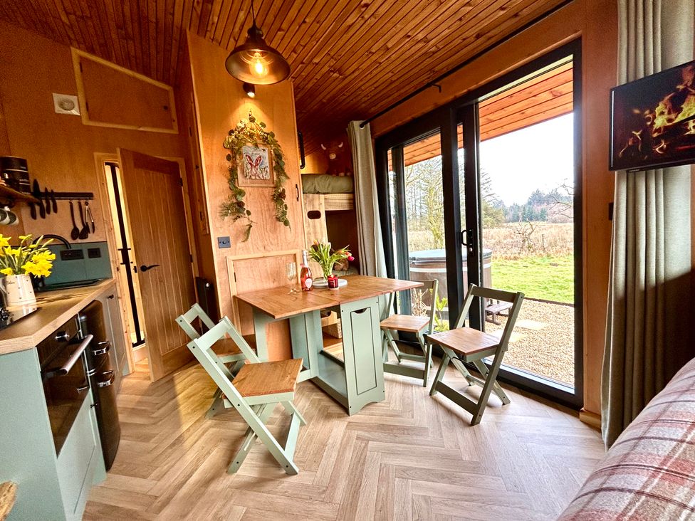 A kitchen with a table and chairs at Harriet in Llangurig