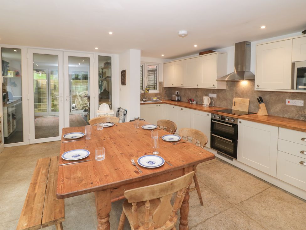 A kitchen with a table and chairs at The Woods 