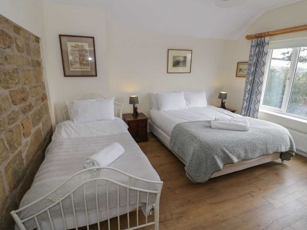 A bedroom with two beds and a window at The Woods in 