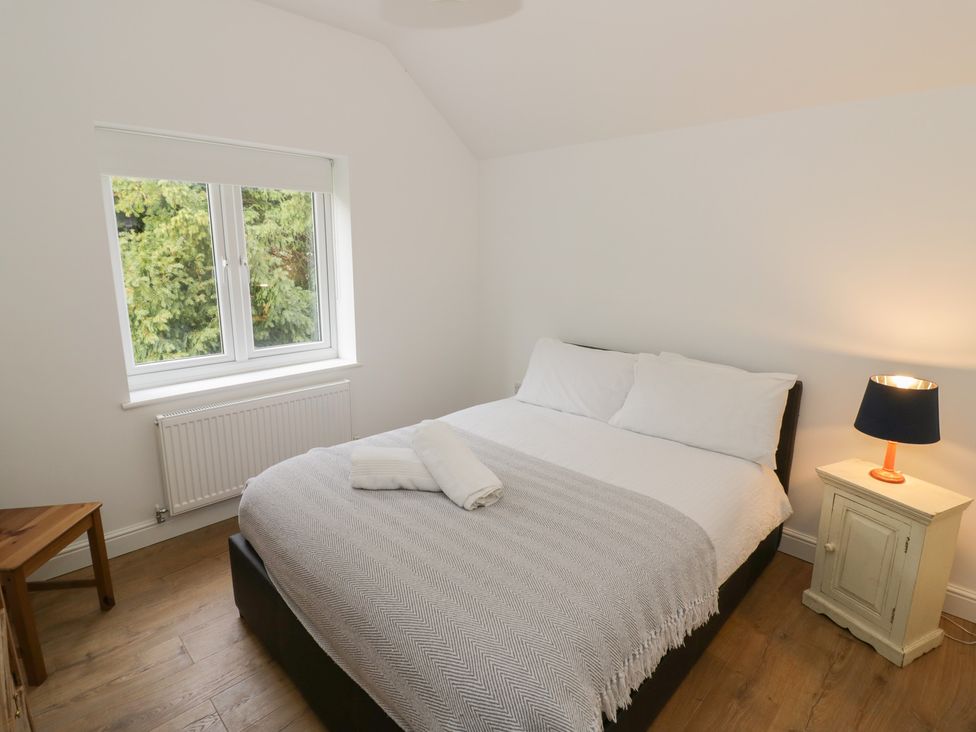A bedroom with a bed and window at The Woods
