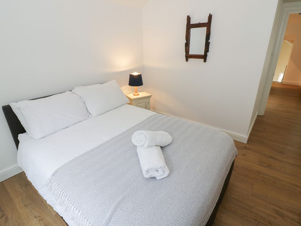 A bedroom with a bed and a nightstand at The Woods