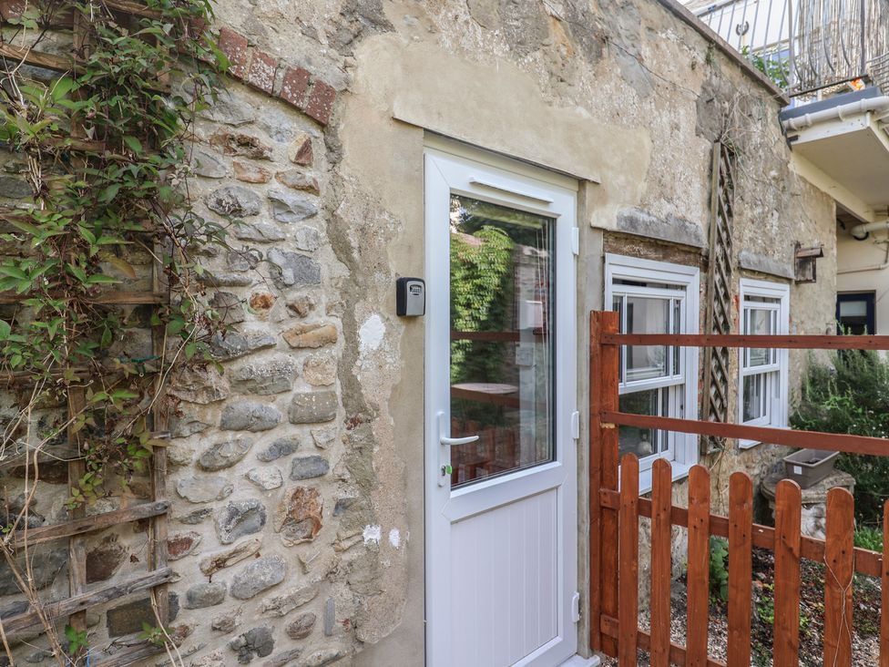 An exterior view of a building with a door and windows at Garden Studio at Stanley House Charmouth