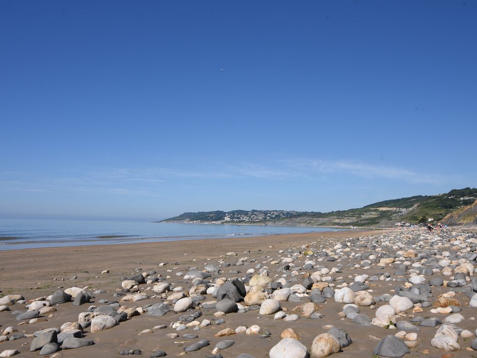 A beach with rocks and water at Garden Studio at Stanley House Charmouth