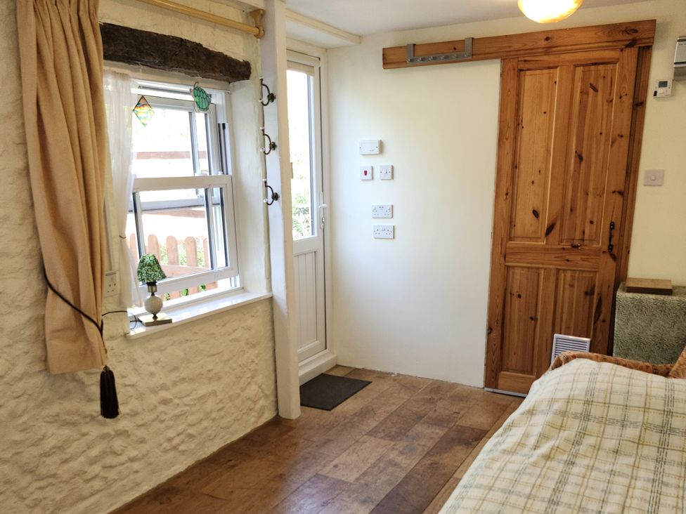 An indoor photo showing a window, door, and wooden features at Garden Studio at Stanley House Charmouth