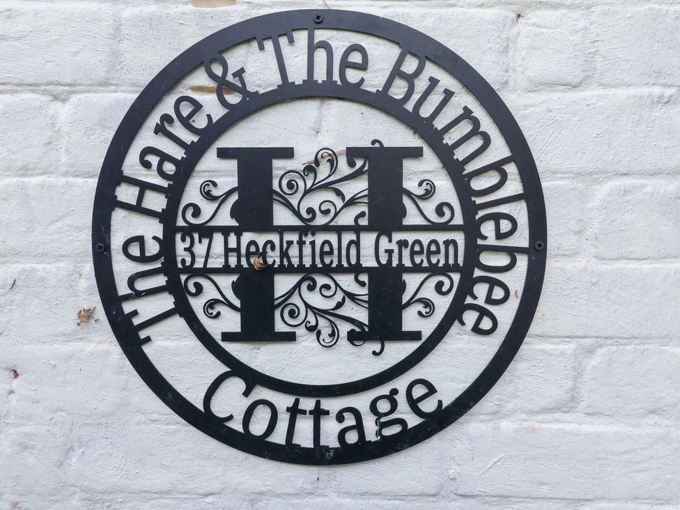 A sign displaying the name and address at The Hare & the Bumblebee Cottage in 37 Heckfield Green