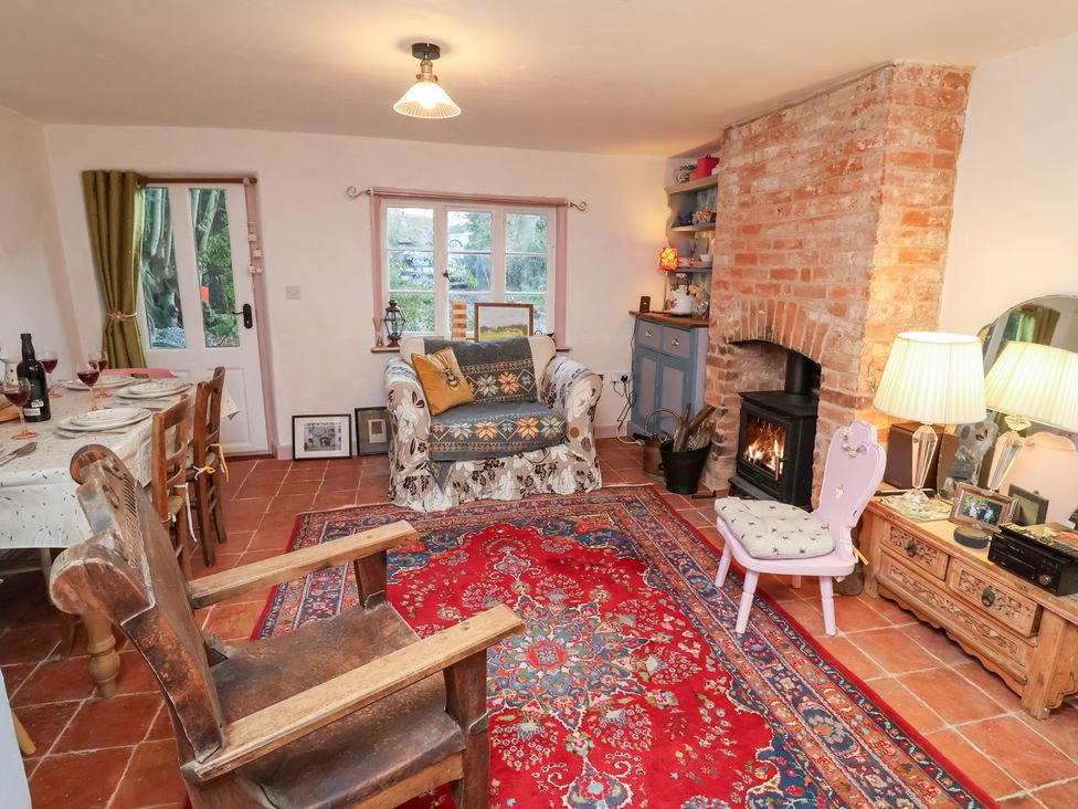 A living room with a couch and fireplace at The Hare & the Bumblebee Cottage