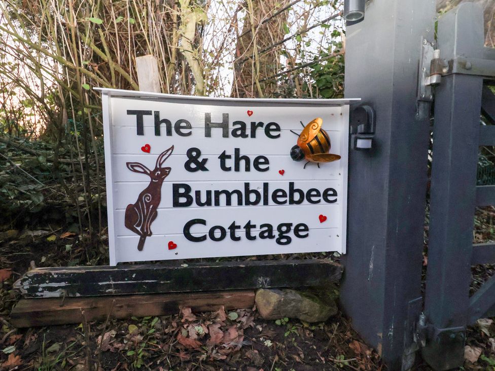 A sign with a rabbit and bee at The Hare & the Bumblebee Cottage
