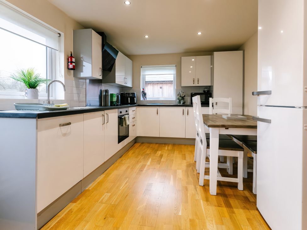 A kitchen with a table and chairs at Aspen Lodge in Brigg