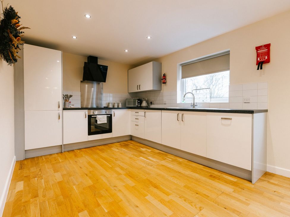 A kitchen with appliances and cabinets at Sage Lodge in Brigg