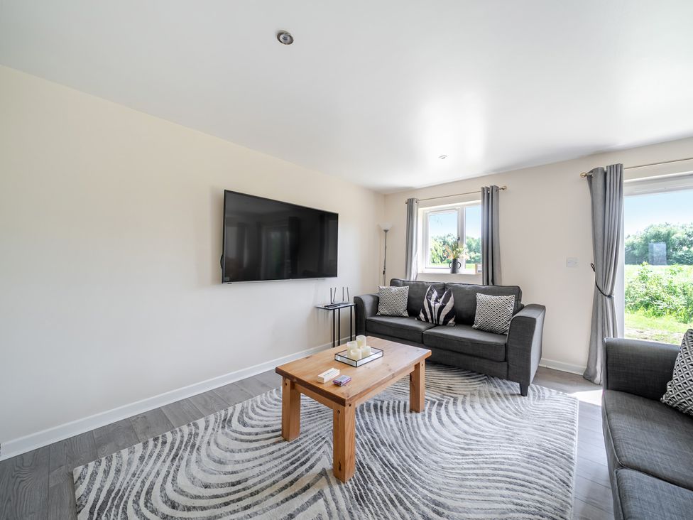 A living room with a sofa and coffee table at Raven Lodge Near Brigg