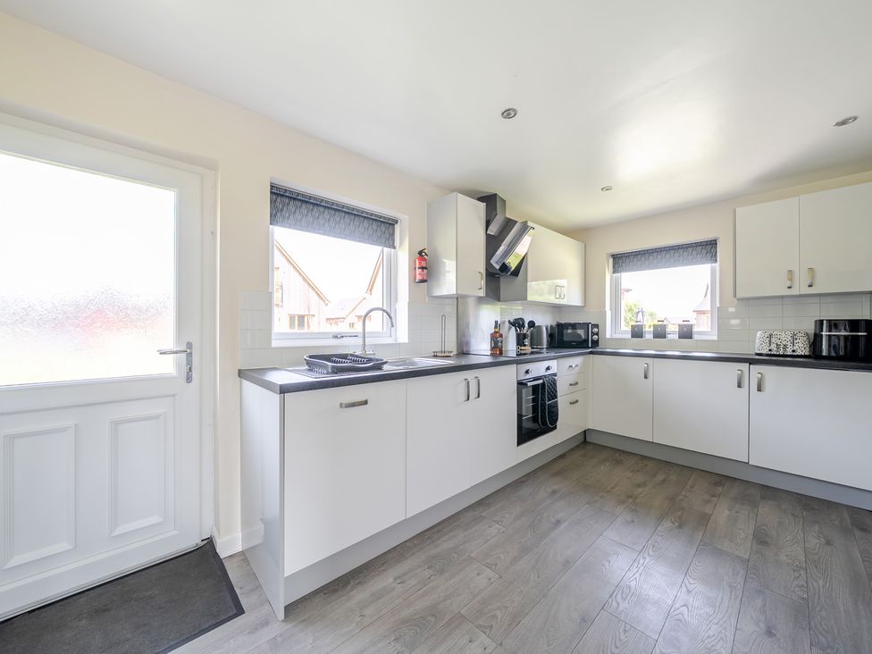 A kitchen with cabinets and appliances at Raven Lodge Near Brigg