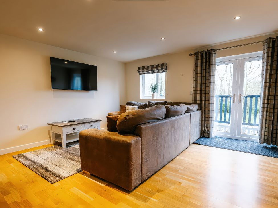 A living room with a sofa and television at Paddington Lodge in Brigg