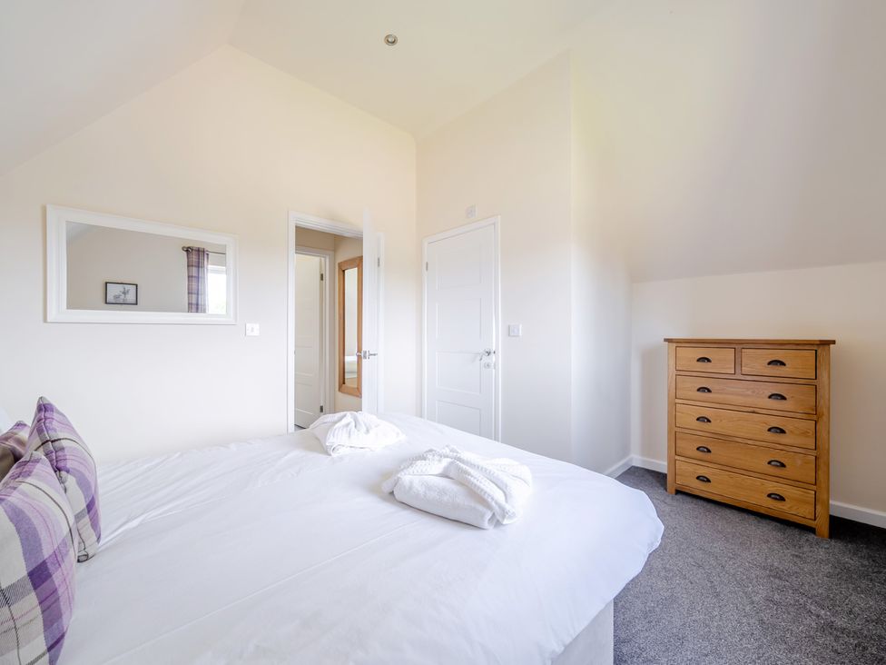 A bedroom with a bed and chest of drawers at Paddington Lodge near Brigg