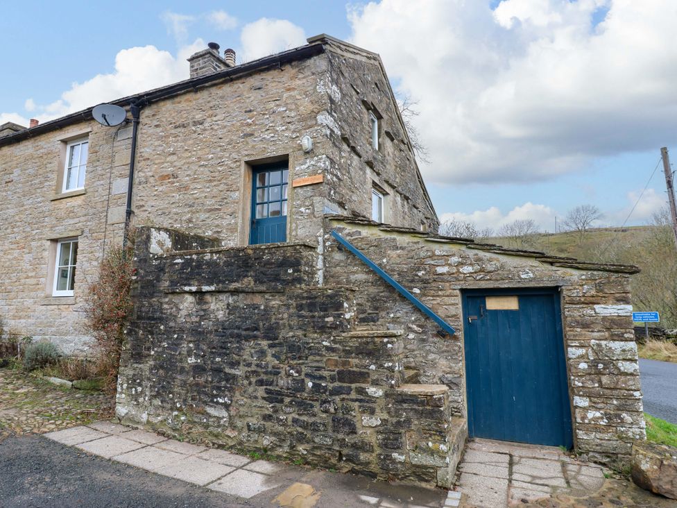 A house with steps and a blue door at Wain Wath Cottage in Richmond