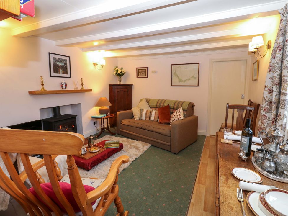 A living room with a sofa and dining table at Wain Wath Cottage in Richmond
