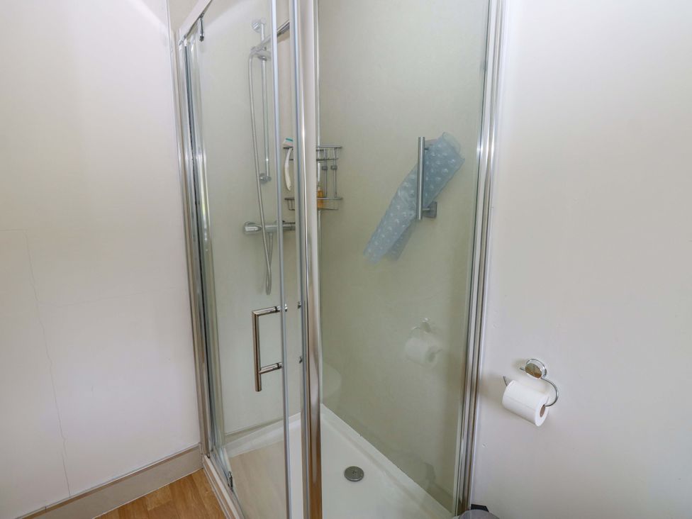 A shower cubicle with shower head and controls at Wain Wath Cottage in Richmond
