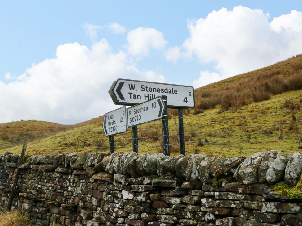 A signpost indicating directions at Wain Wath Cottage in Richmond