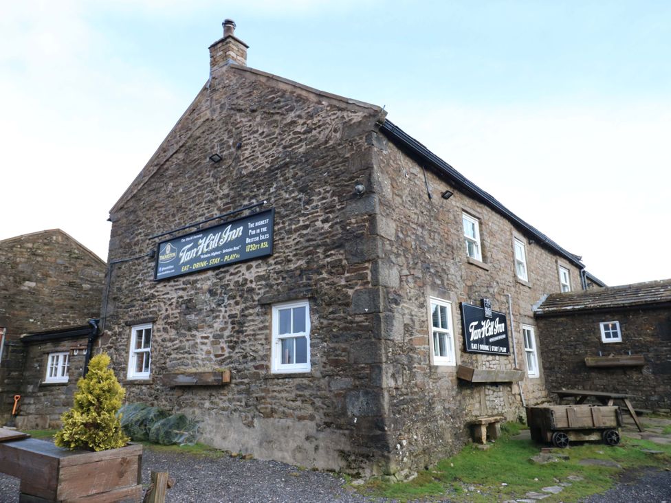 An exterior view of Tan Hill Inn with a sign at Tan Hill Inn in Richmond