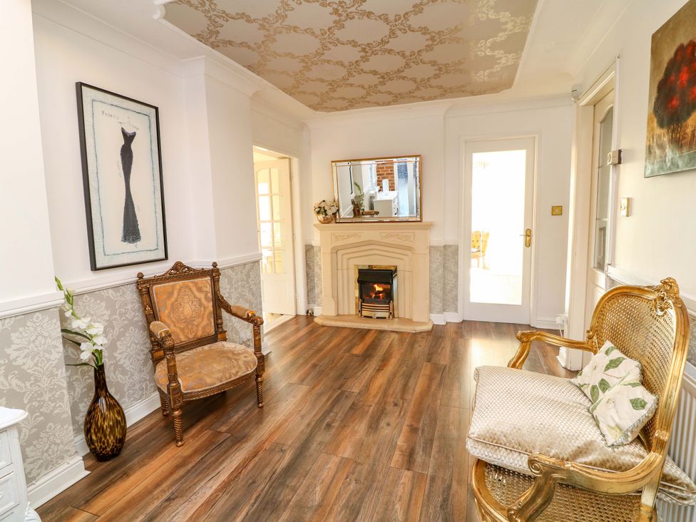 A living room with an armchair and fireplace at 12 Wyndham Road Loughborough