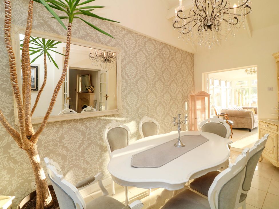 A dining room with a table and chairs at 12 Wyndham Road in Loughborough