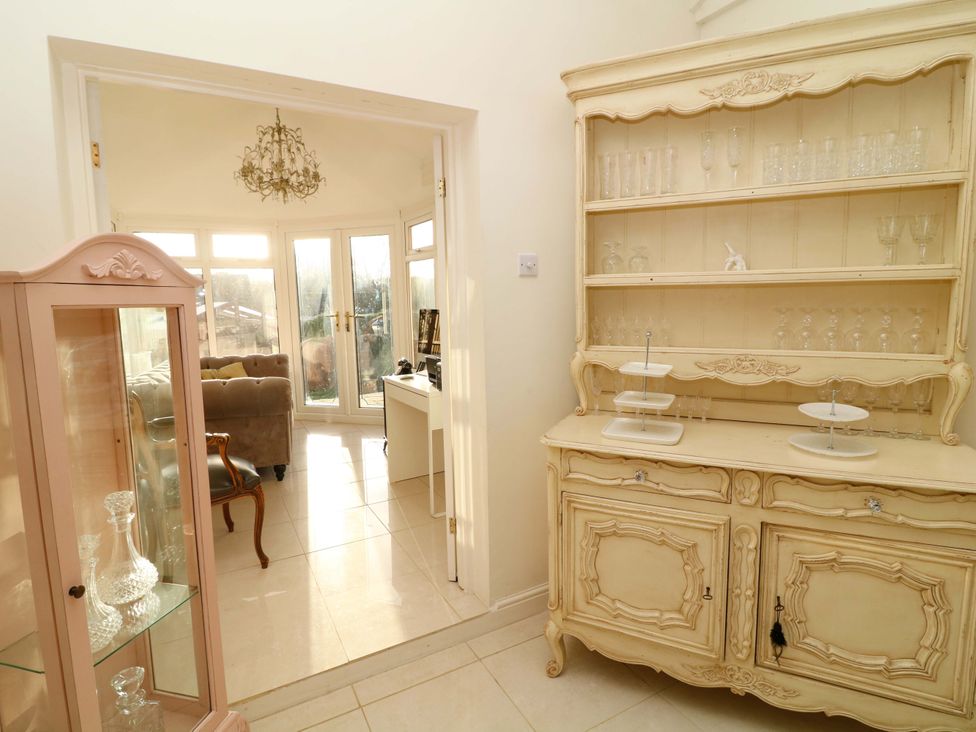 A display cabinet and shelves in a dining room at 12 Wyndham Road Loughborough