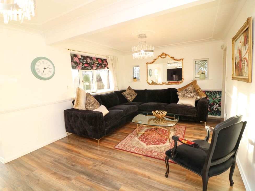 A living room with a sectional sofa and coffee table at 12 Wyndham Road in Loughborough
