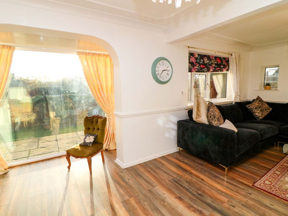A living room with a sofa and chair at 12 Wyndham Road in Loughborough