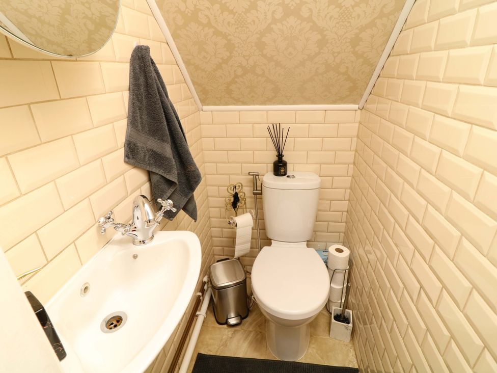 A bathroom with a toilet and sink at 12 Wyndham Road in Loughborough